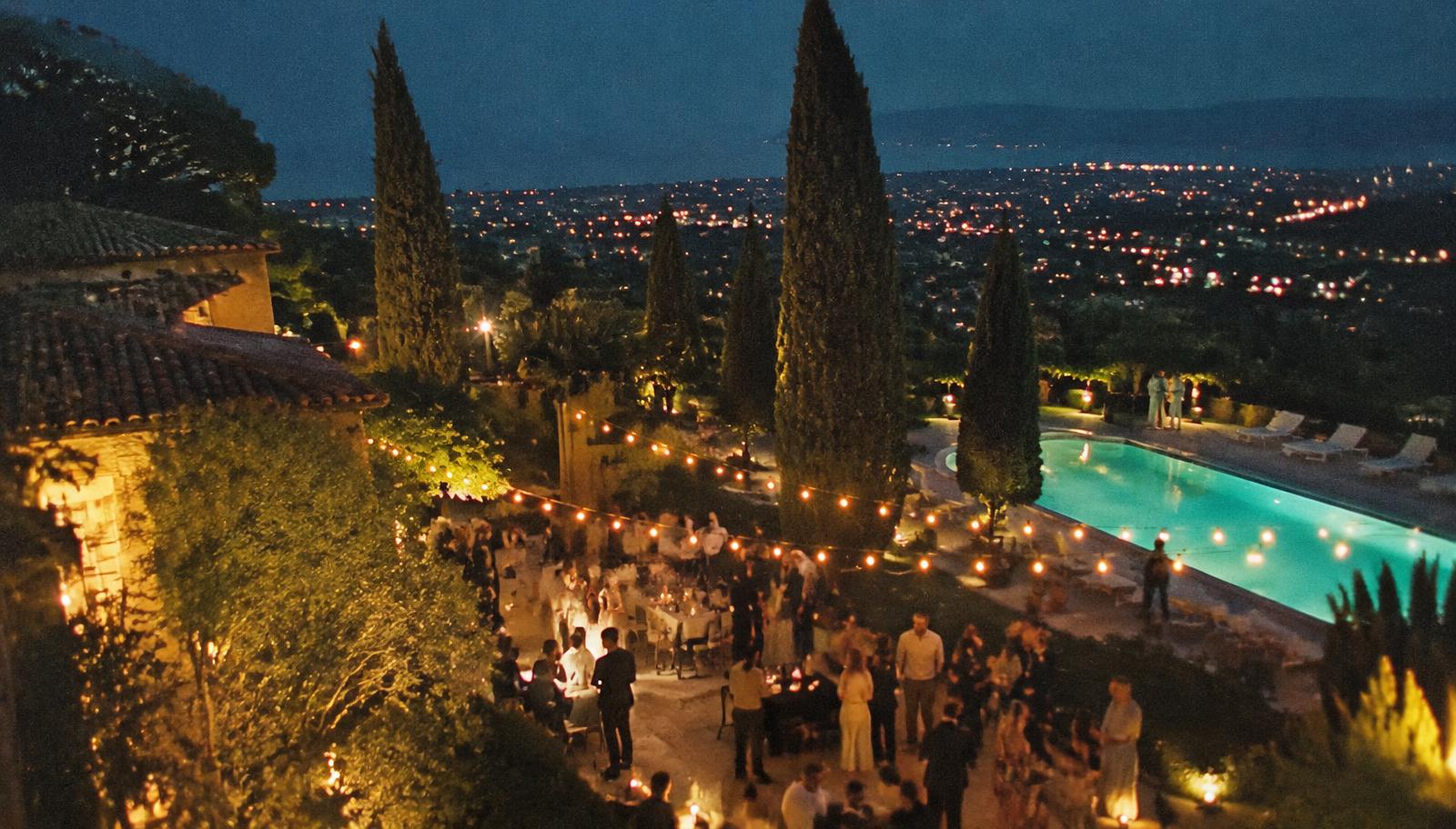 A villa party under string lights